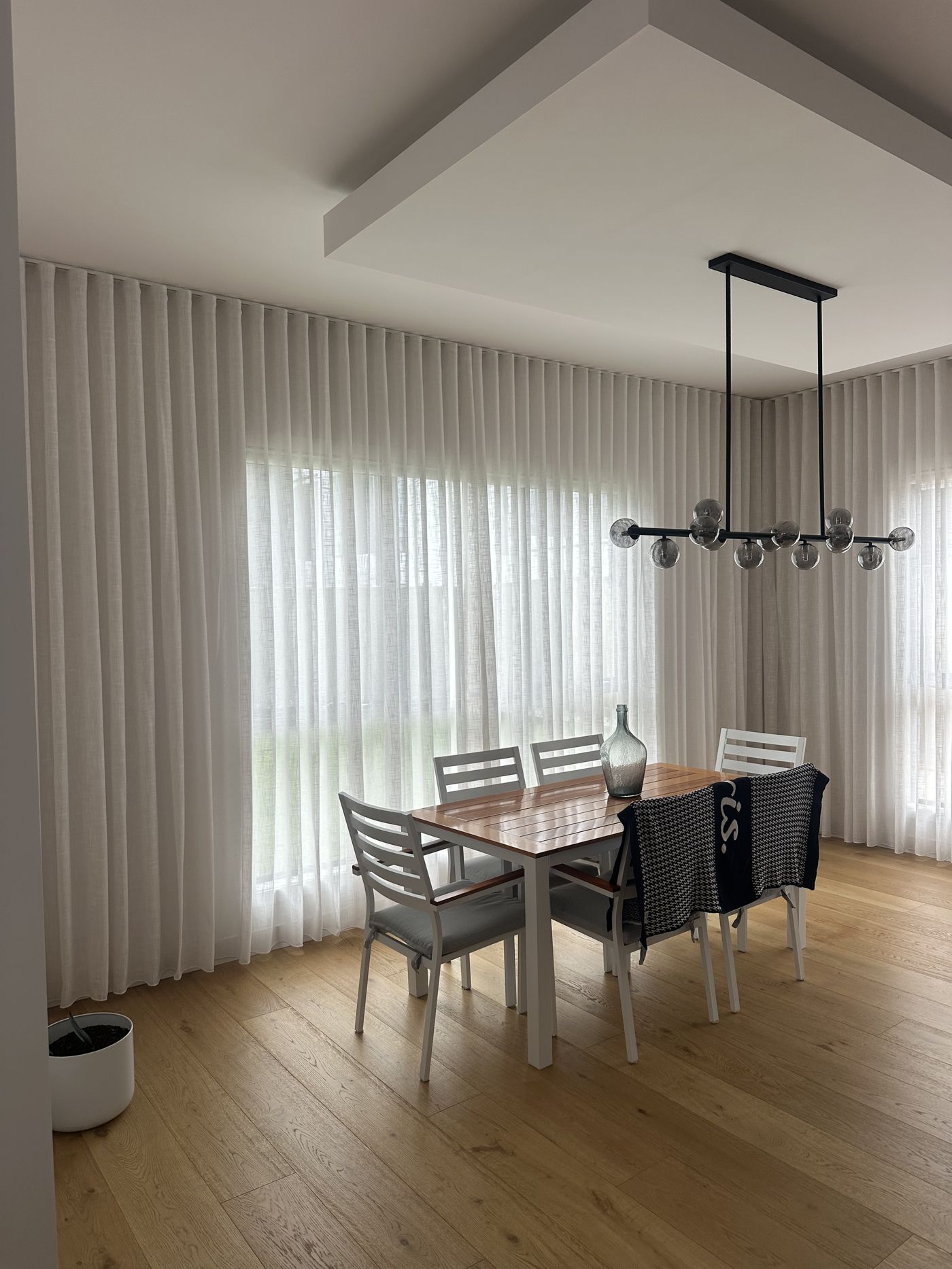 S-fold sheer curtains in a dining room